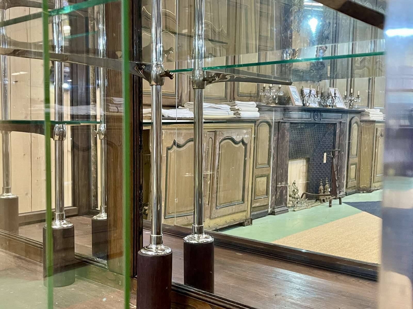 Early 20th-century shop display cabinet in oak with sliding doors.