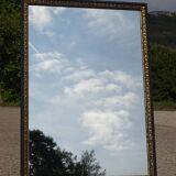 Mirror with black and gold frame, embossed vine leaves