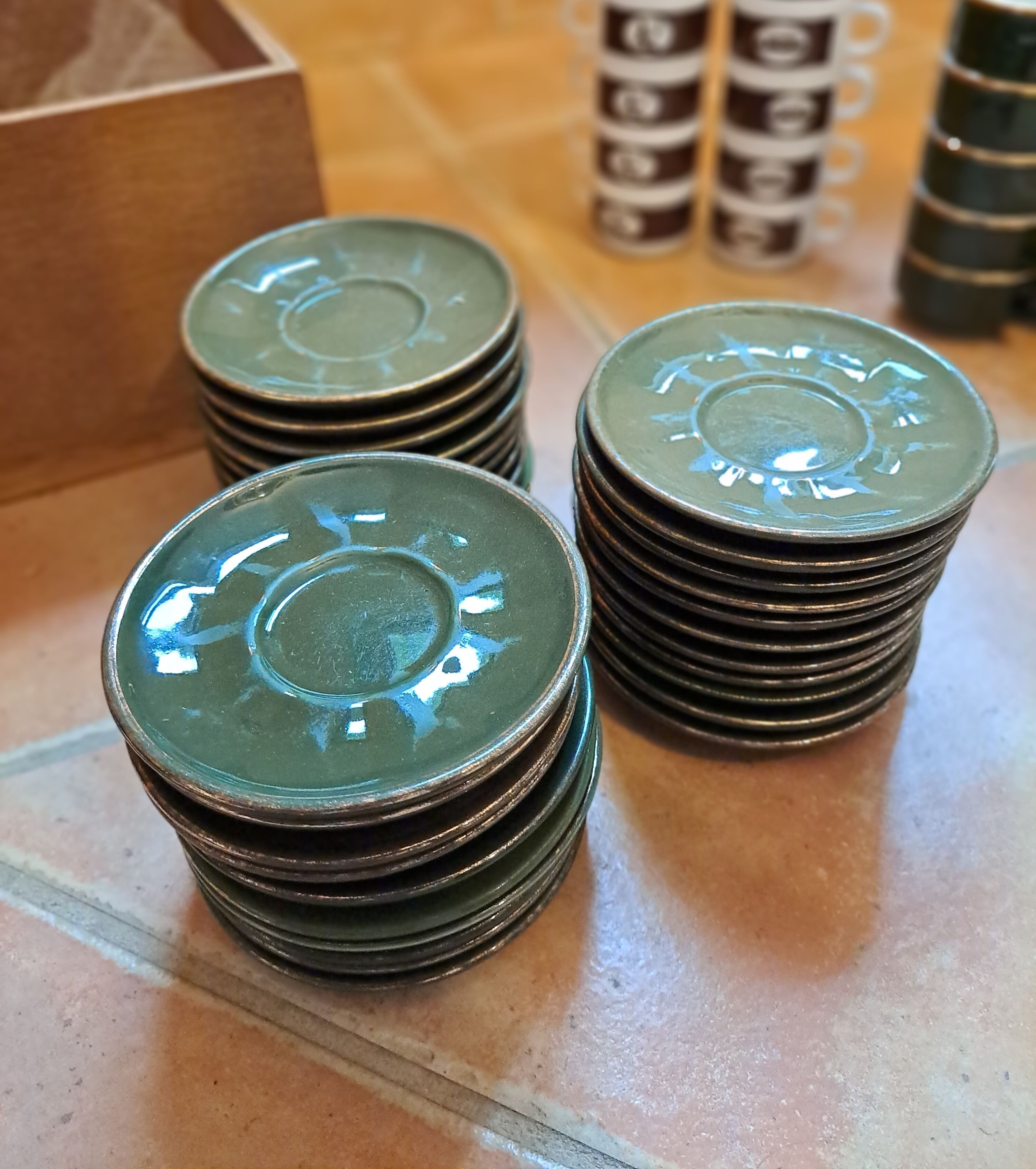 Green and gold coffee cups and sub-cups