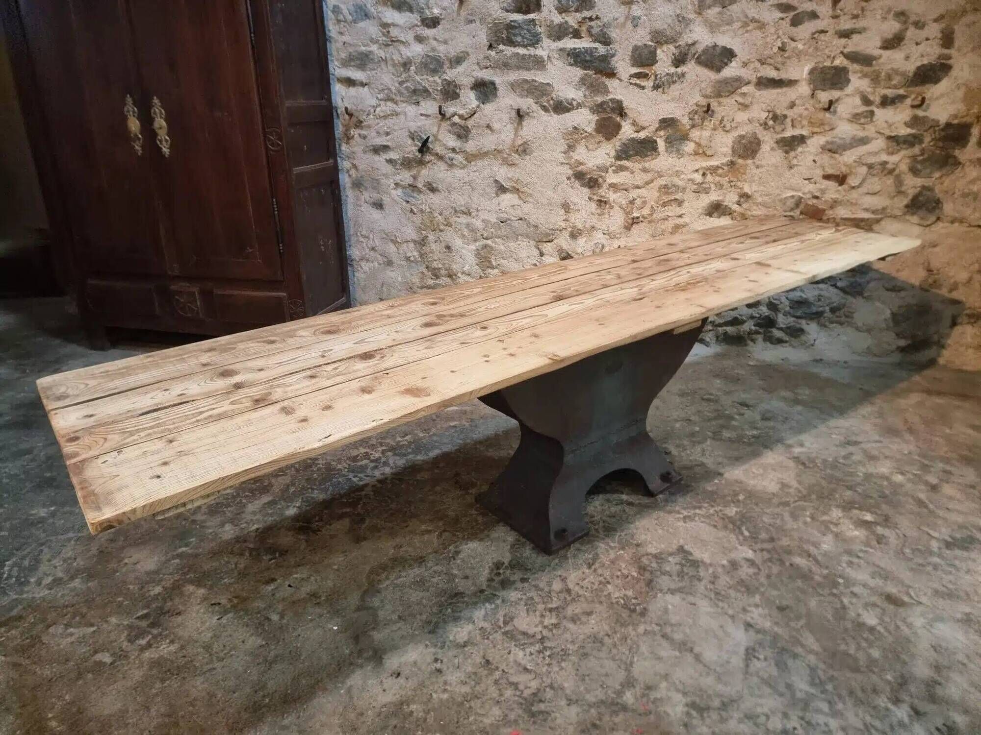 Old French industrial table with a cast iron base and a pine top.
