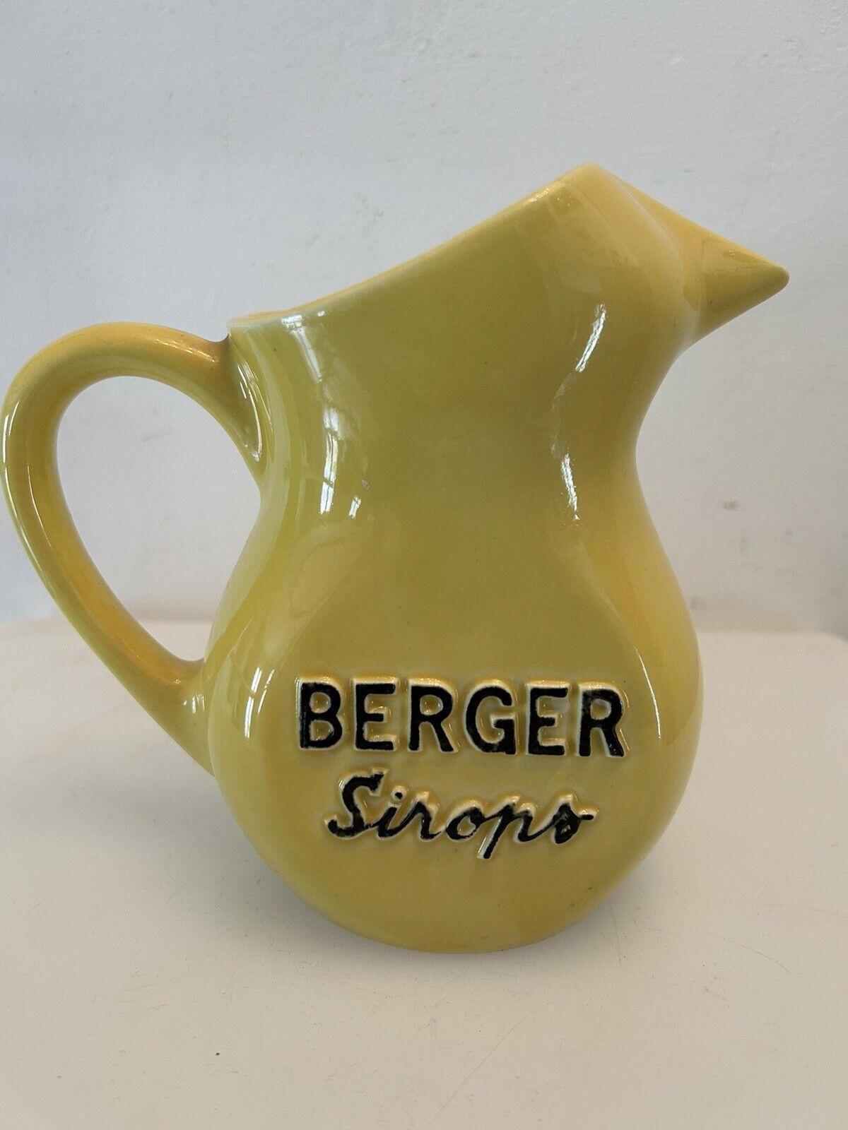 Old yellow pitcher anisette berger syrups, vintage bistro decoration