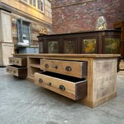 An old piece of workshop furniture transformed into a TV stand