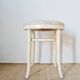 Vintage curved wooden stool in Baumann style, striped seat.