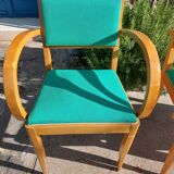 3 vintage bridge chairs with rounded armrests.