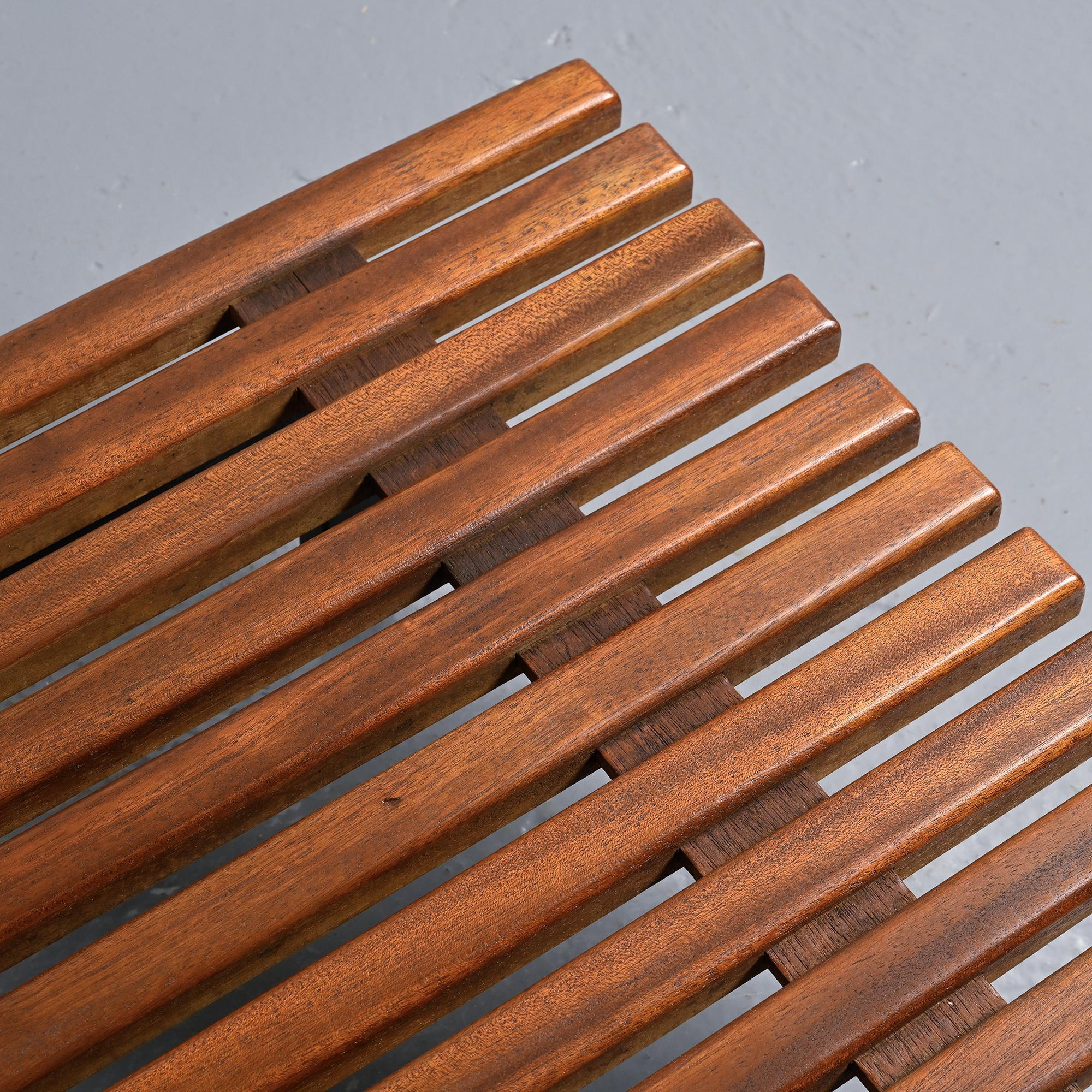 Cansado bench in mahogany by Charlotte Perriand, circa 1962.