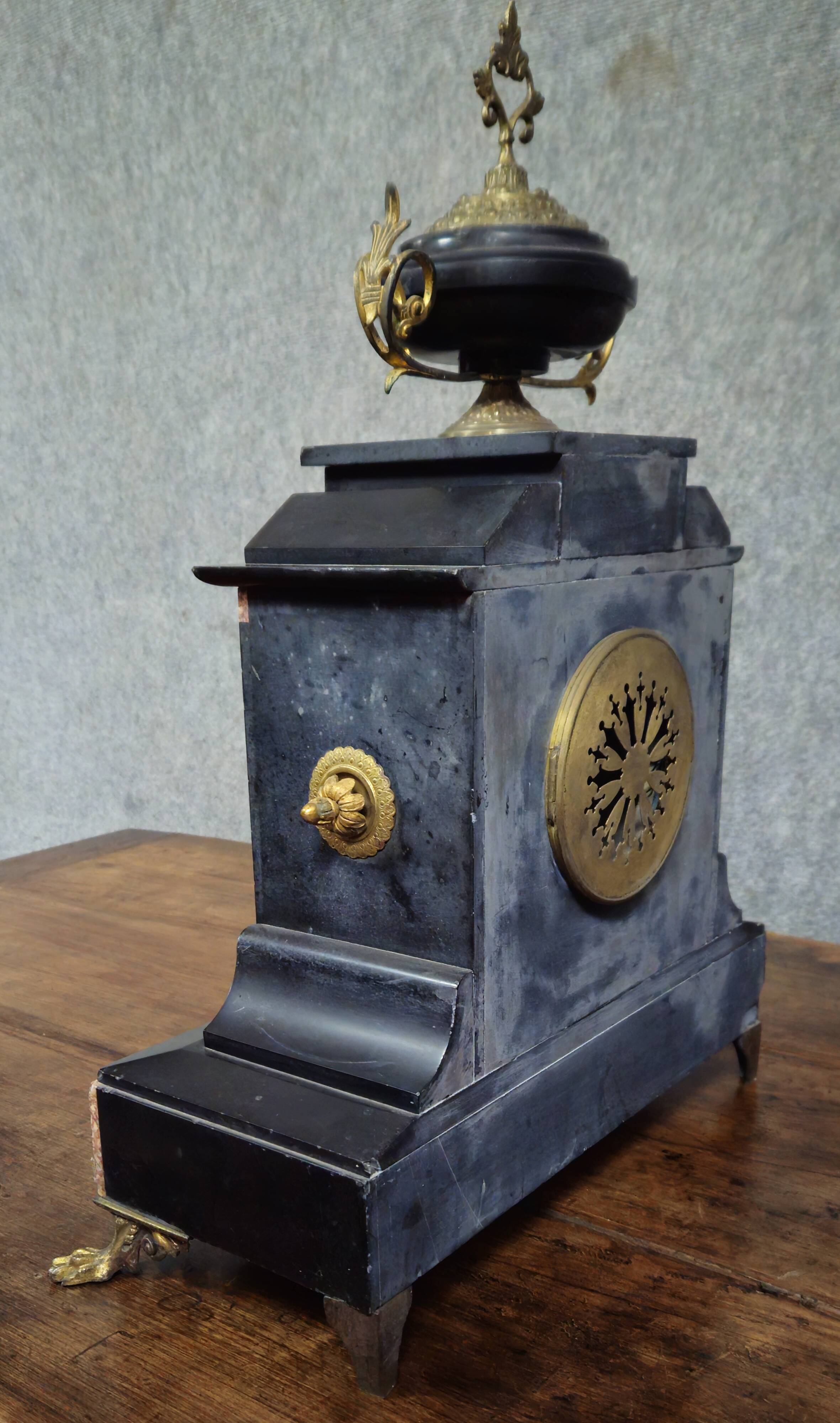 Large notary clock in black marble and gilded bronze.