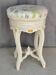 Antique upholstered stool "with screws"