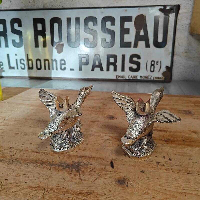 Set of two antique silver-plated duck candlesticks.