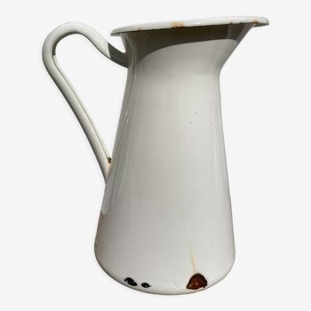 Old white enamelled metal pitcher