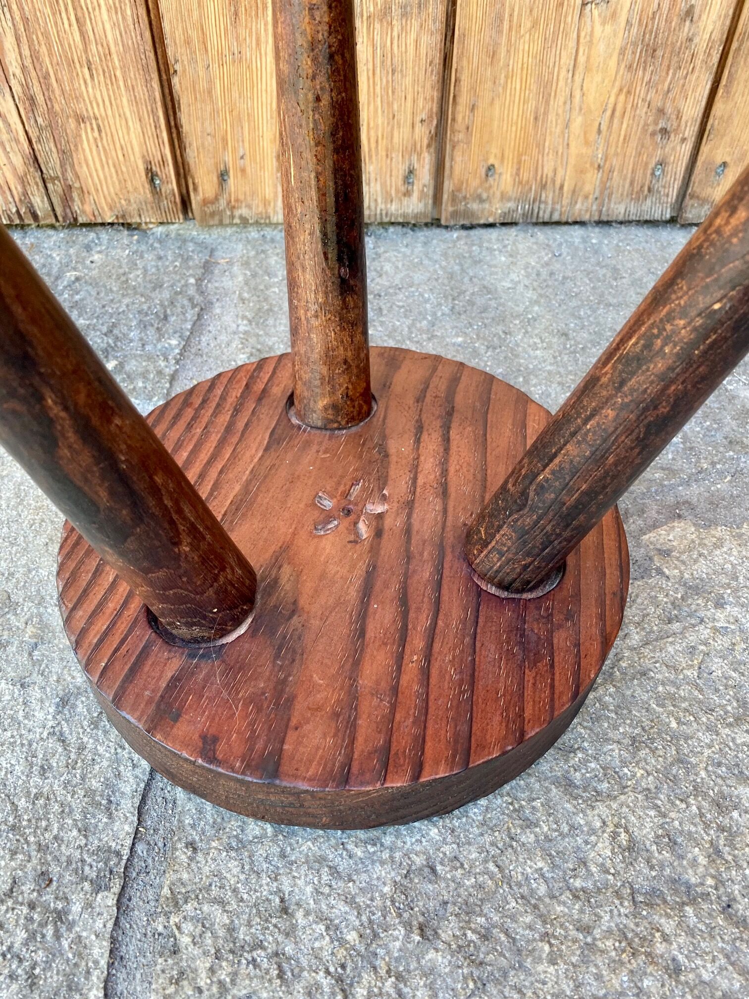 Wooden tripod stool.