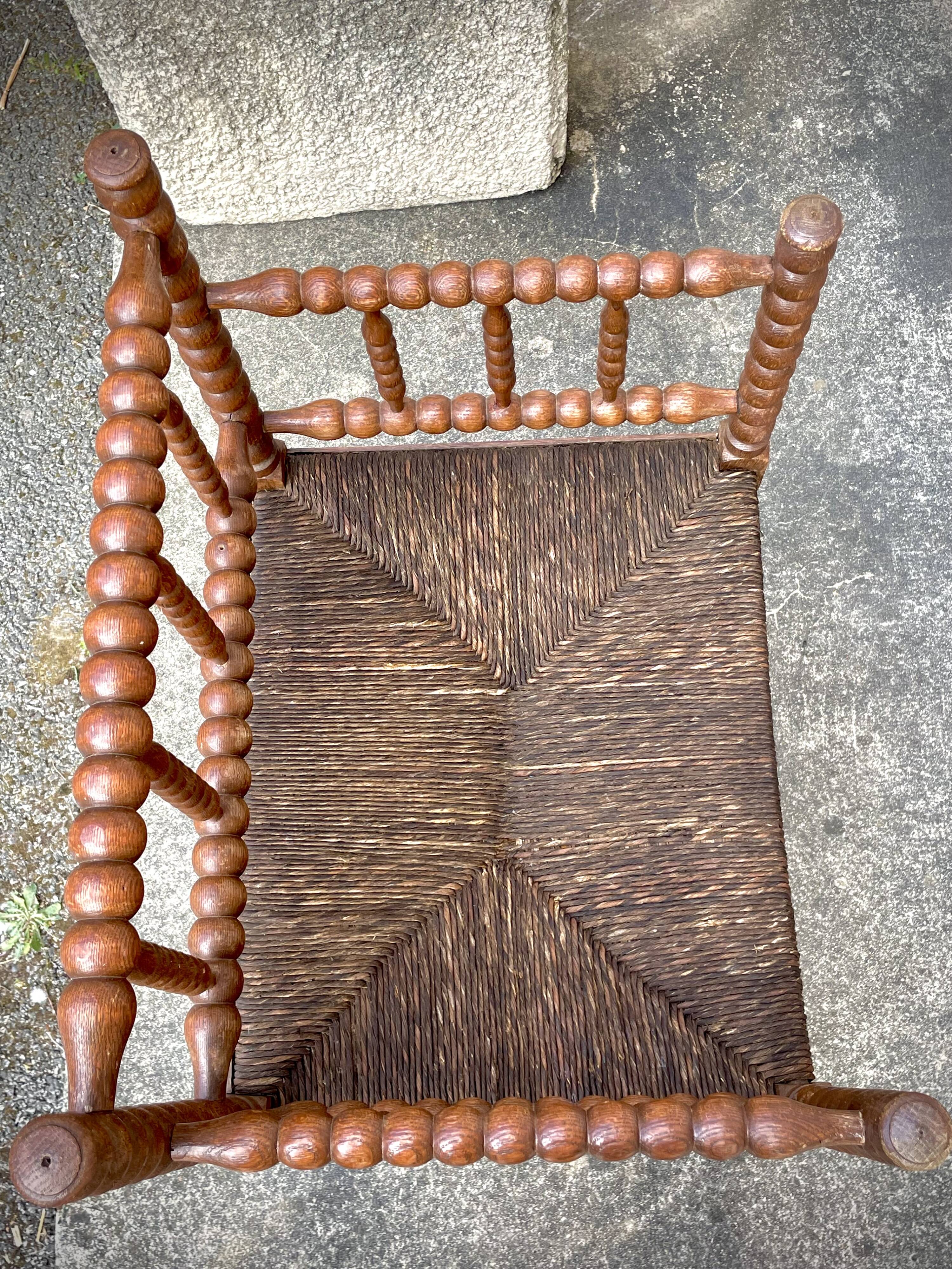 Antique Bobbin armchair with straw seat