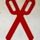 Wooden sign in the shape of scissors