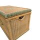 Large vintage wicker chest with green decoration.