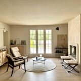 Round ecru rug with geometric relief patterns in wool