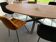 Oval table in solid oak refined edges with central foot in black metal