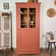 Antique glass-fronted terracotta cupboard