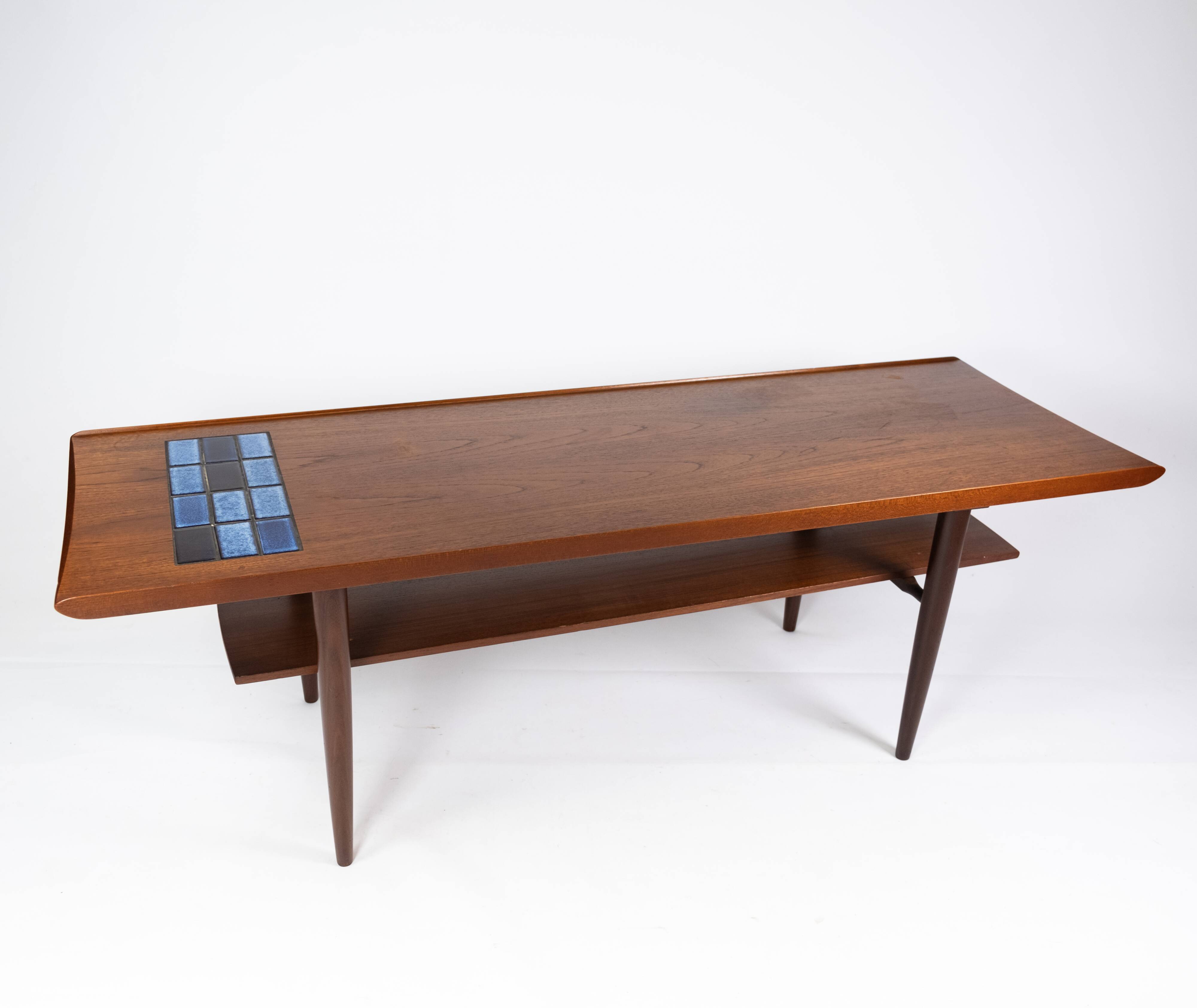 Coffee table in teak with blue tiles of danish design from the 1960s.
