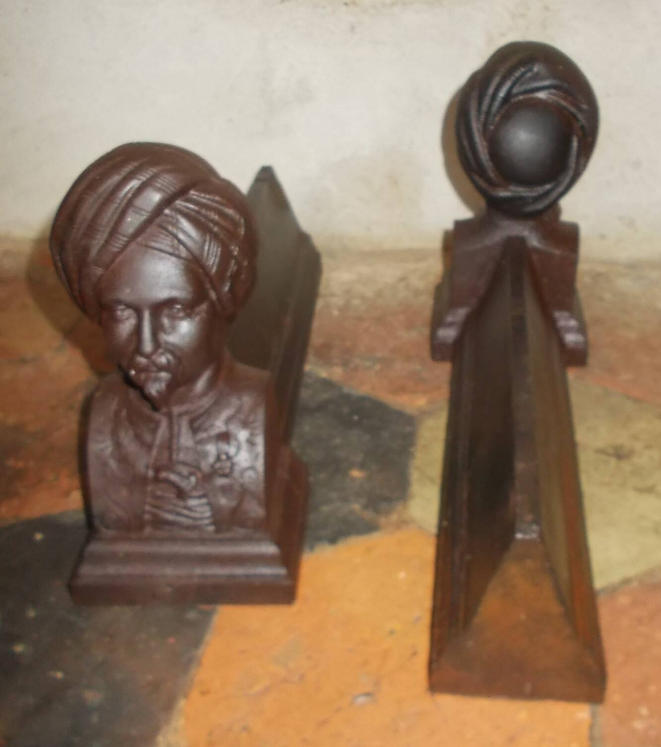 Old cast iron andirons with oriental decor