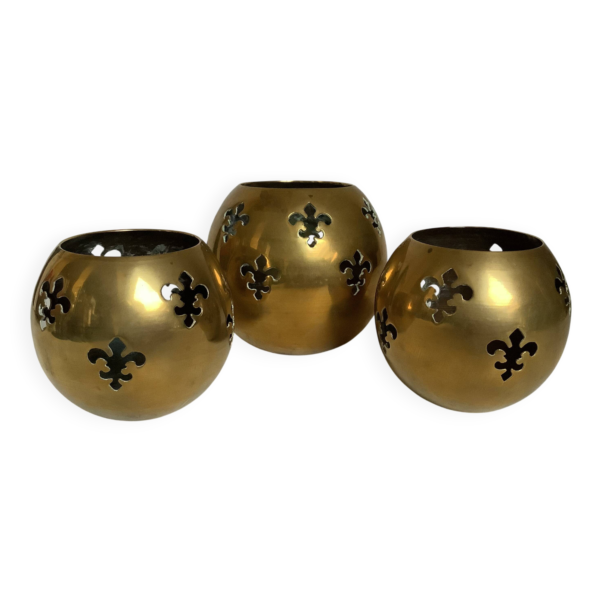 Trio of brass fleur-de-lis candle holders