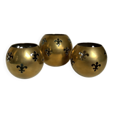 Trio of brass fleur-de-lis candle holders