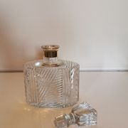 Cut glass carafe with a gold band on the neck.