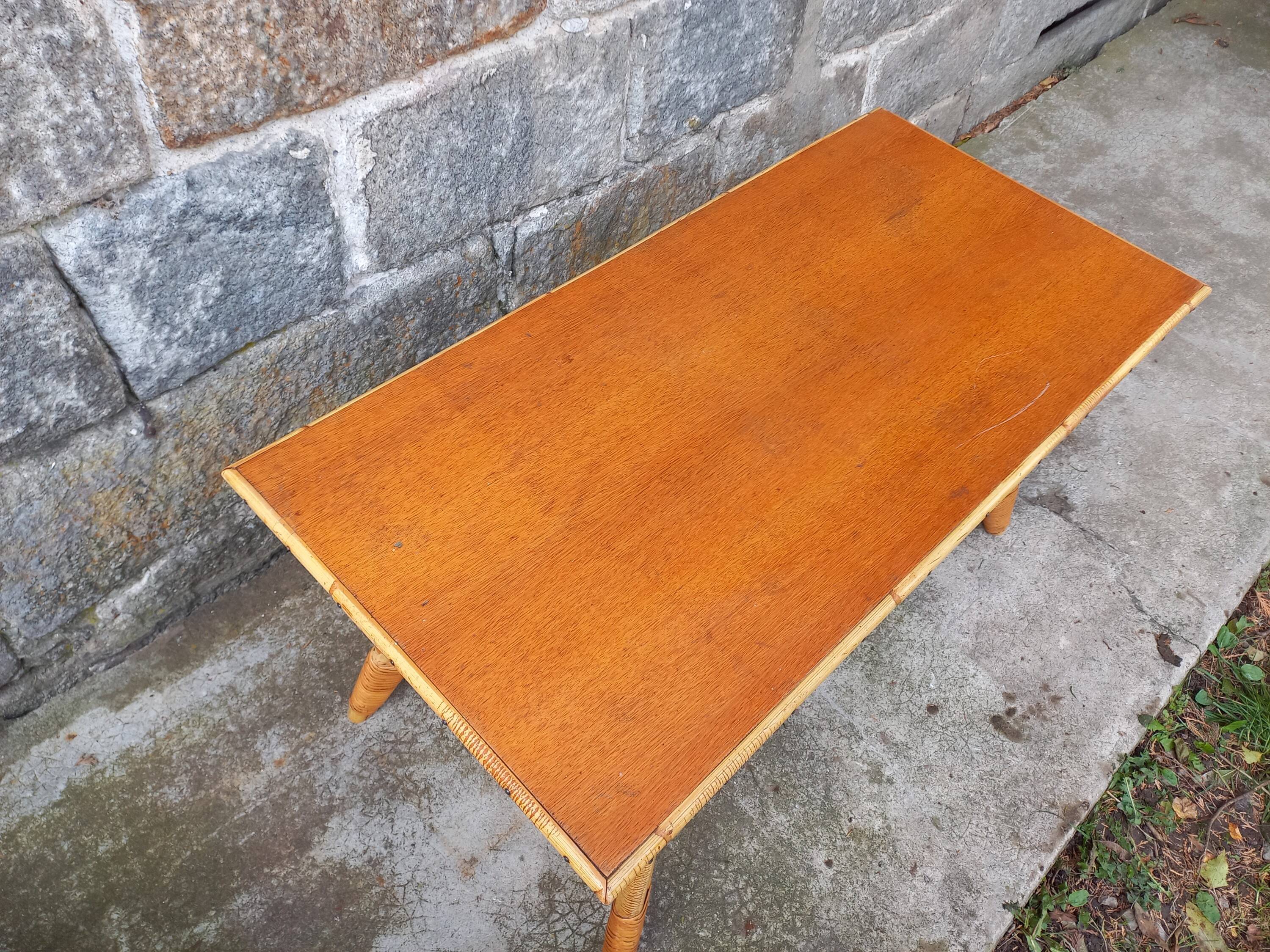 Rattan coffee table with compass legs