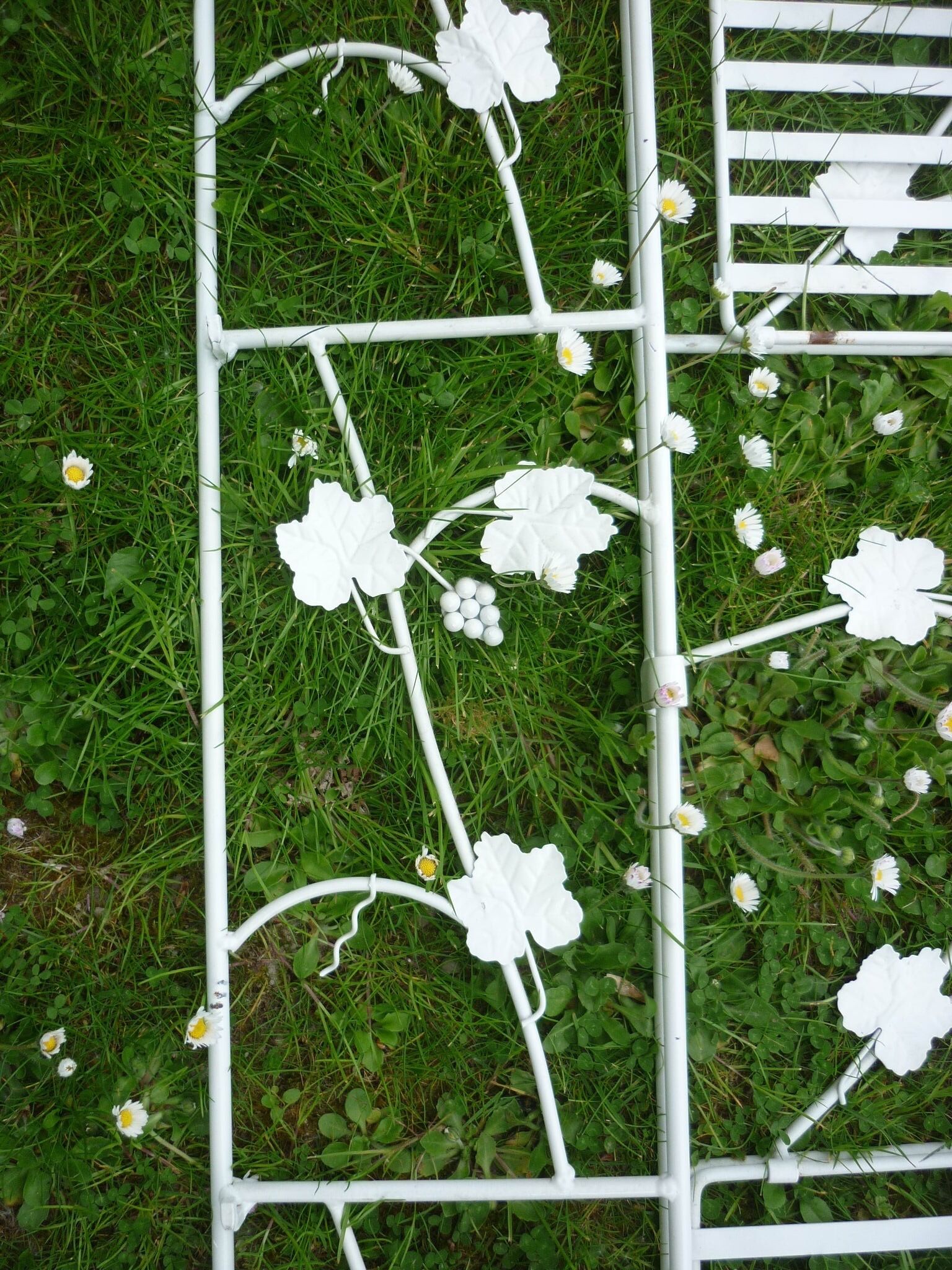 Folding white wrought iron shelf