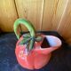 Jug in tomato slipware