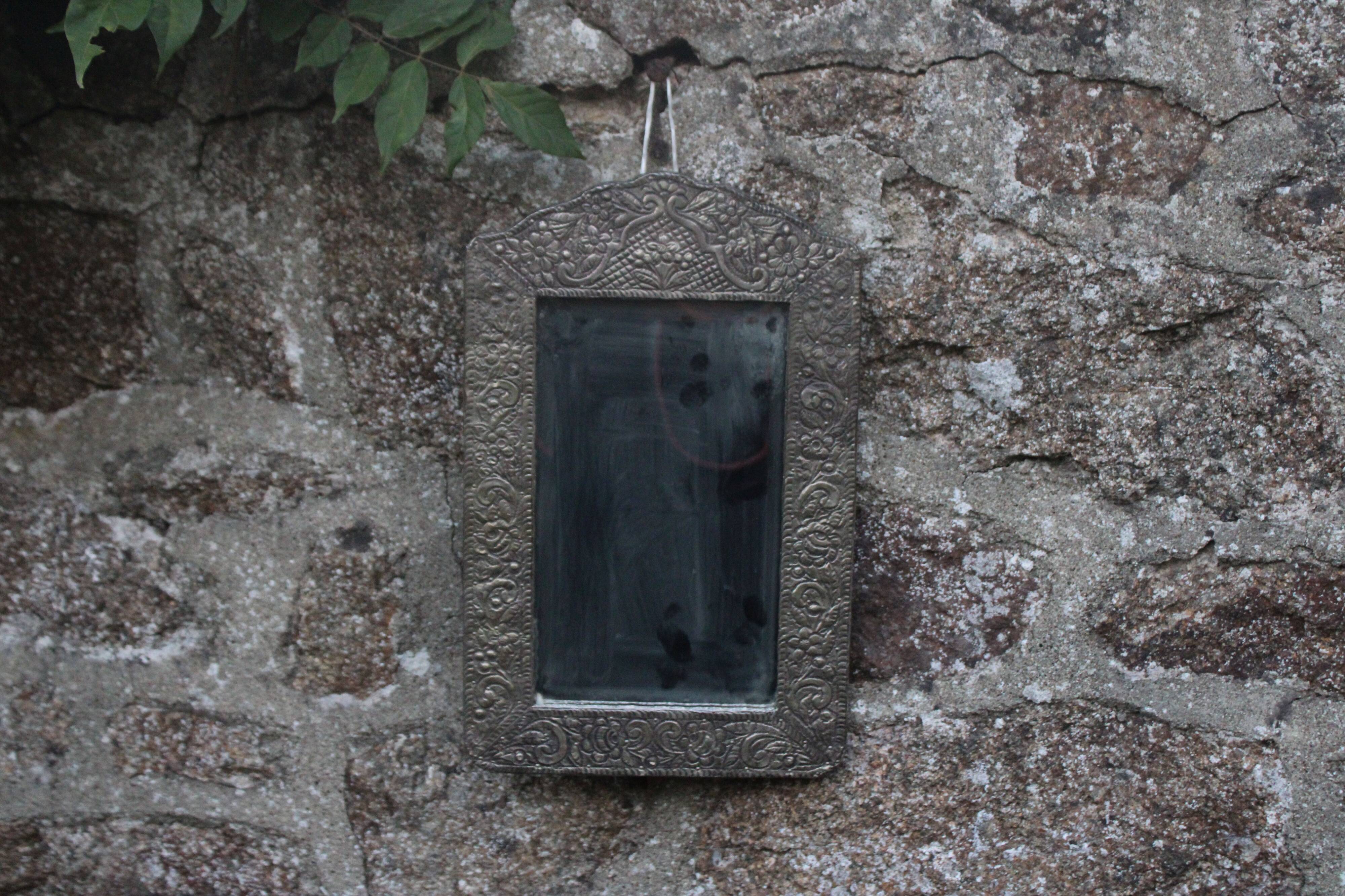 Oriental mirror in chiseled metal – beveled, for placing on a surface or hanging