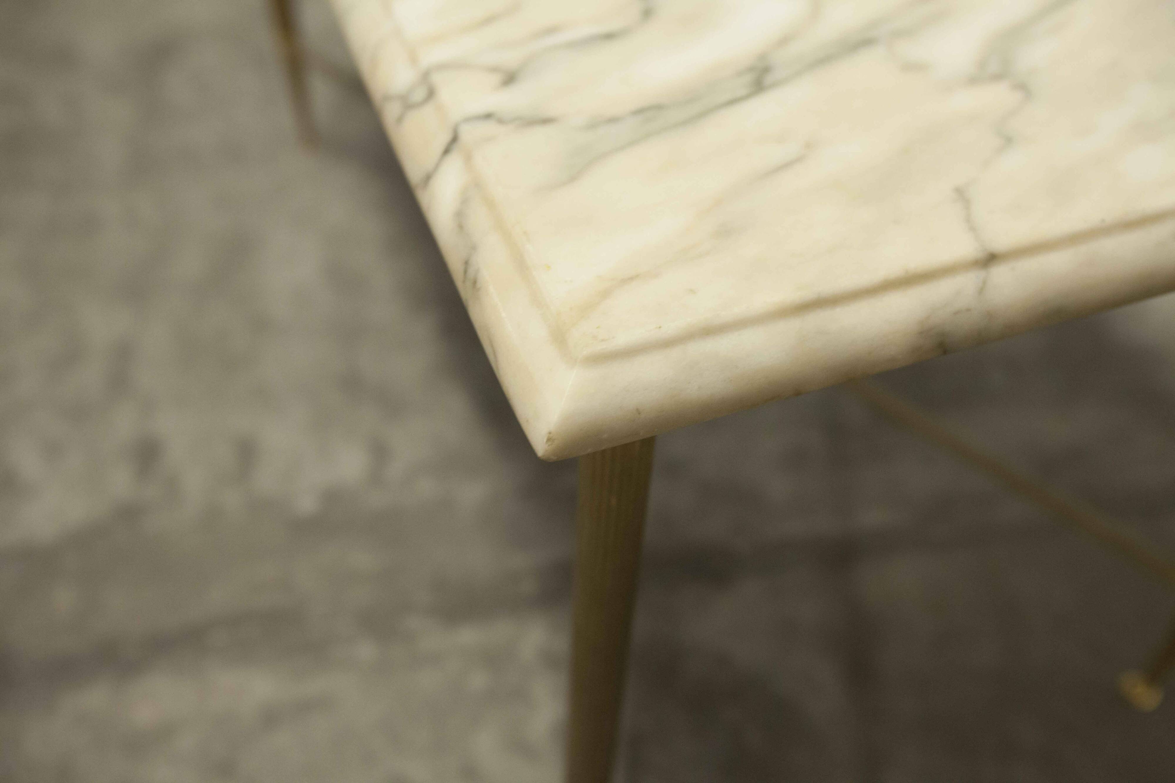 Marble coffee table with brass legs, height 46 cm.