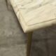 Marble coffee table with brass legs, height 46 cm.