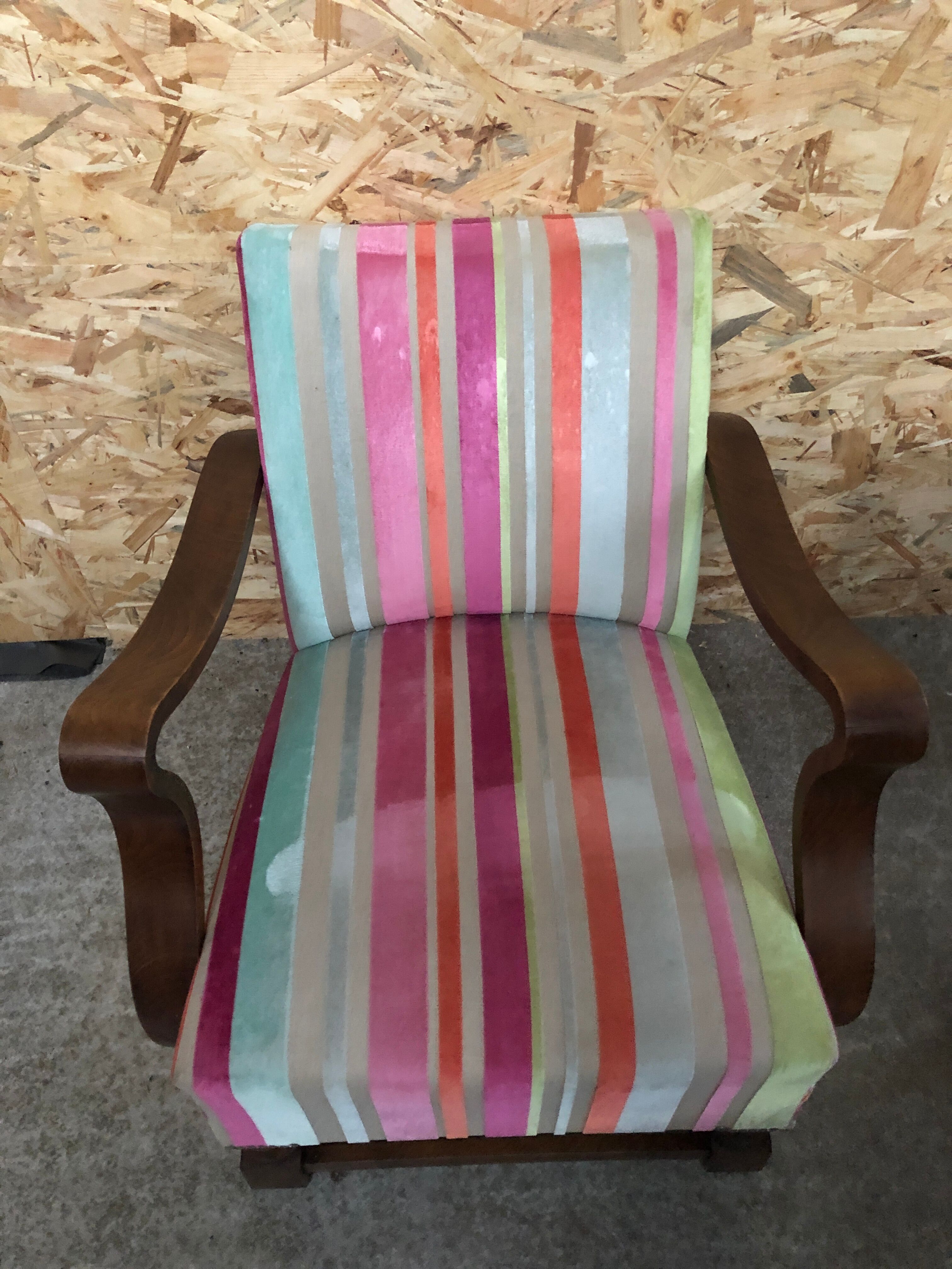 Old wooden armchair with curved armrests