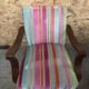 Old wooden armchair with curved armrests