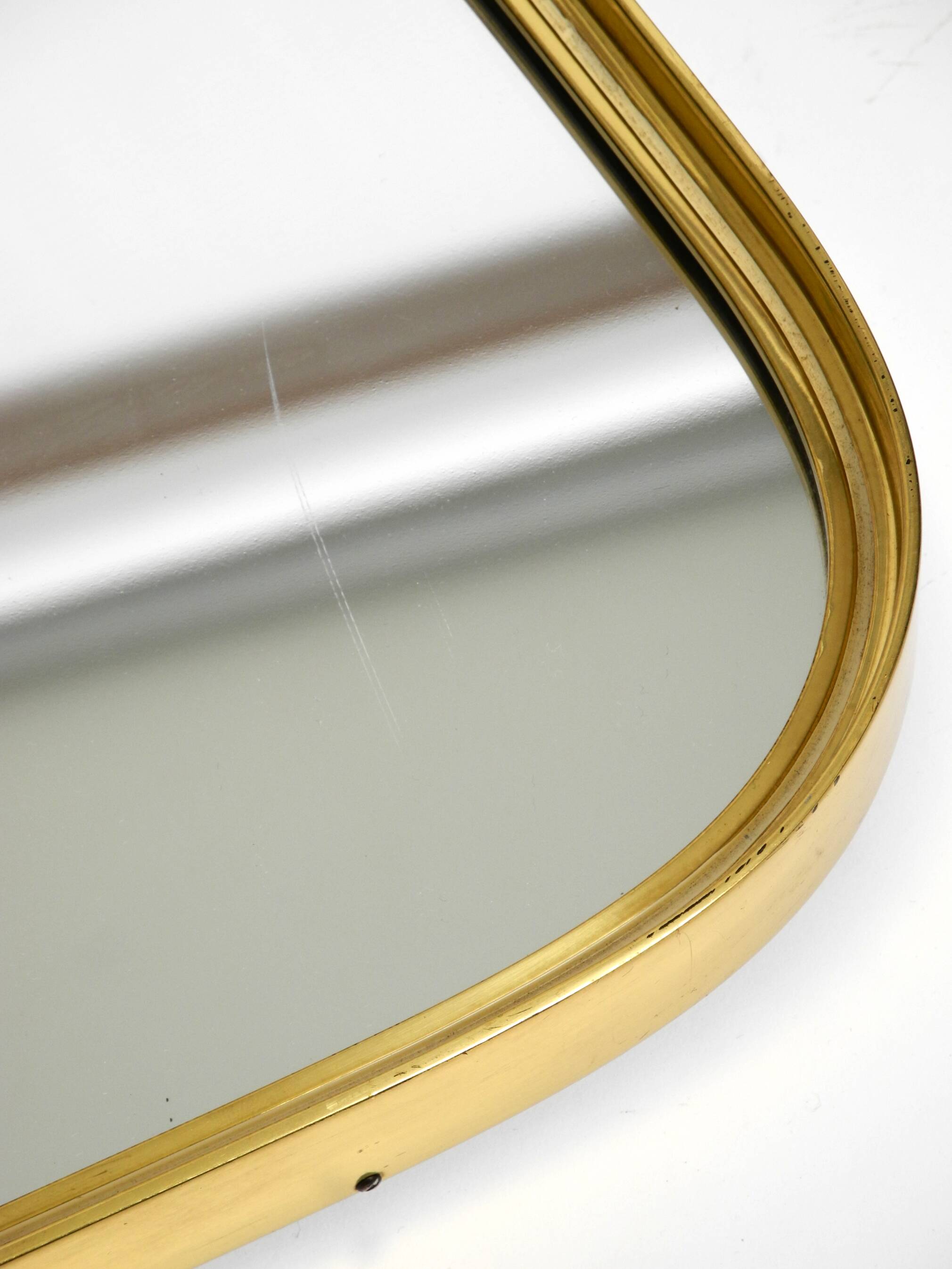 Small solid Mid Century brass wall mirror by Münchener Zierspiegel