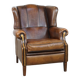 Vintage sheepskin wingback chair finished with black piping