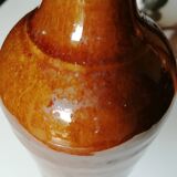 Old bottle in varnished ground.