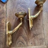 Pair of bronze wall sconces with outstretched arms and hands
