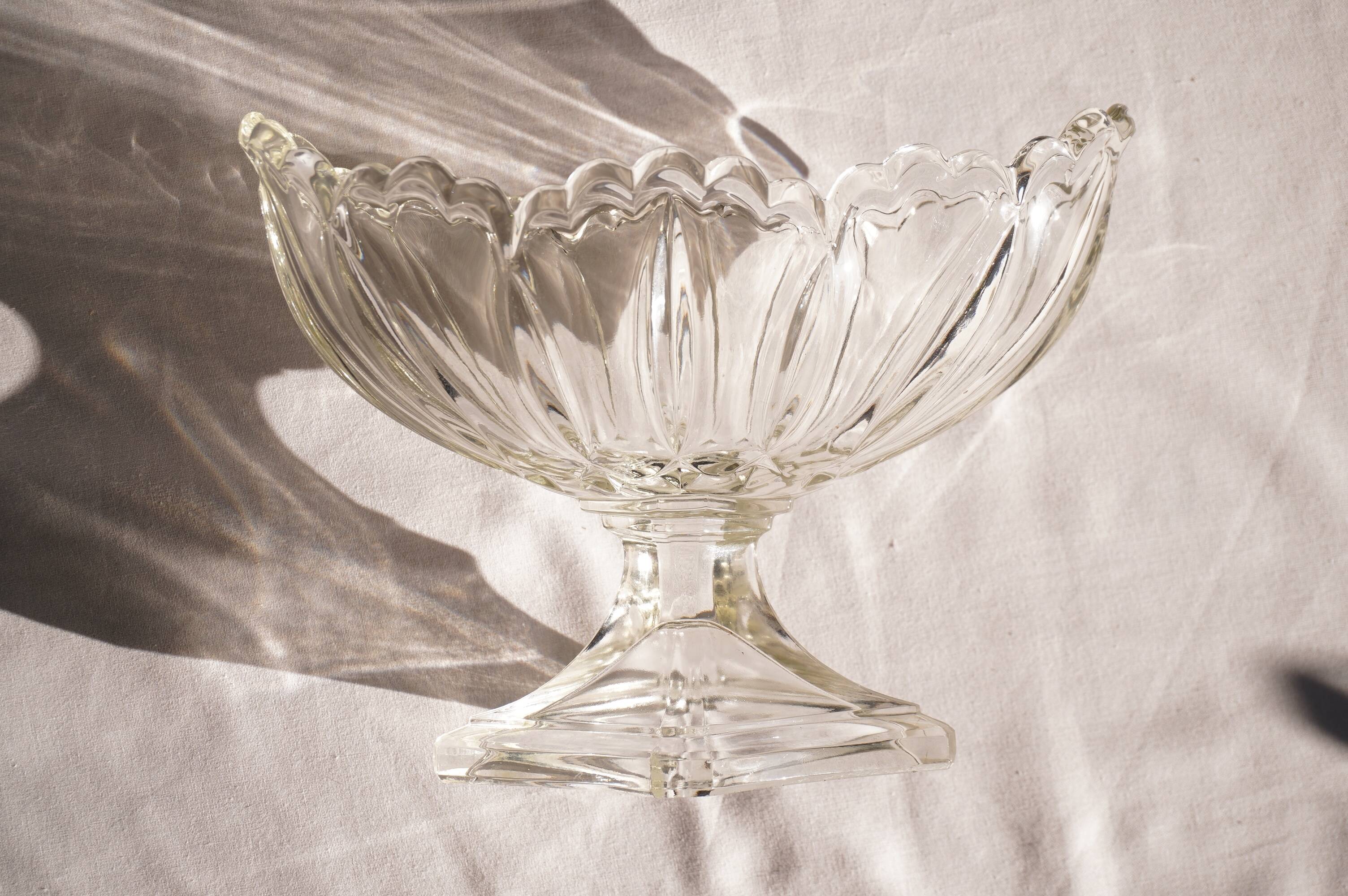 Oval glass fruit bowl on a stand.