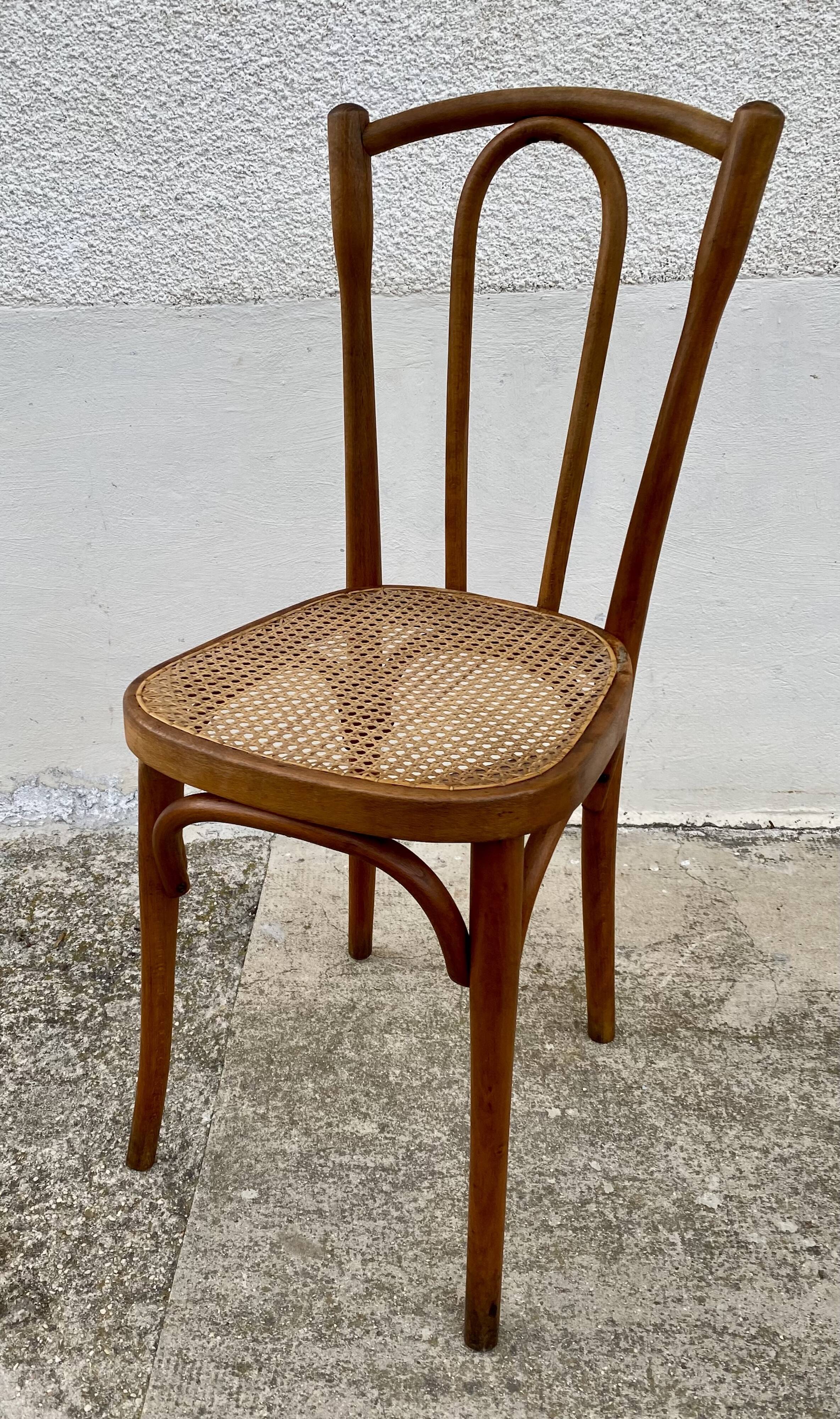 19th-century bistro chair, signed, with caned seat.