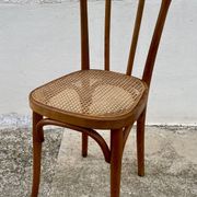 19th-century bistro chair, signed, with caned seat.