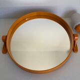 Tilting orange plastic mirror with its matching wall light
