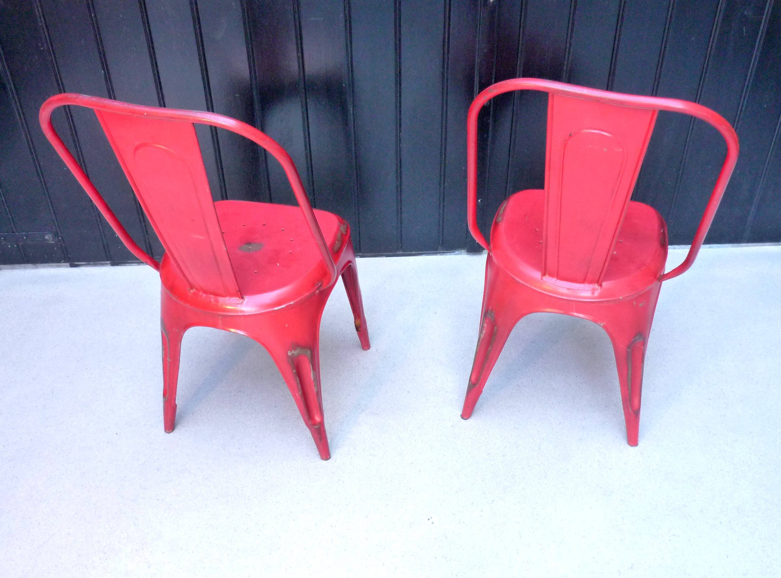 Pair of red stackable metal chairs