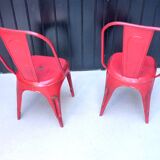 Pair of red stackable metal chairs