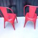 Pair of red stackable metal chairs