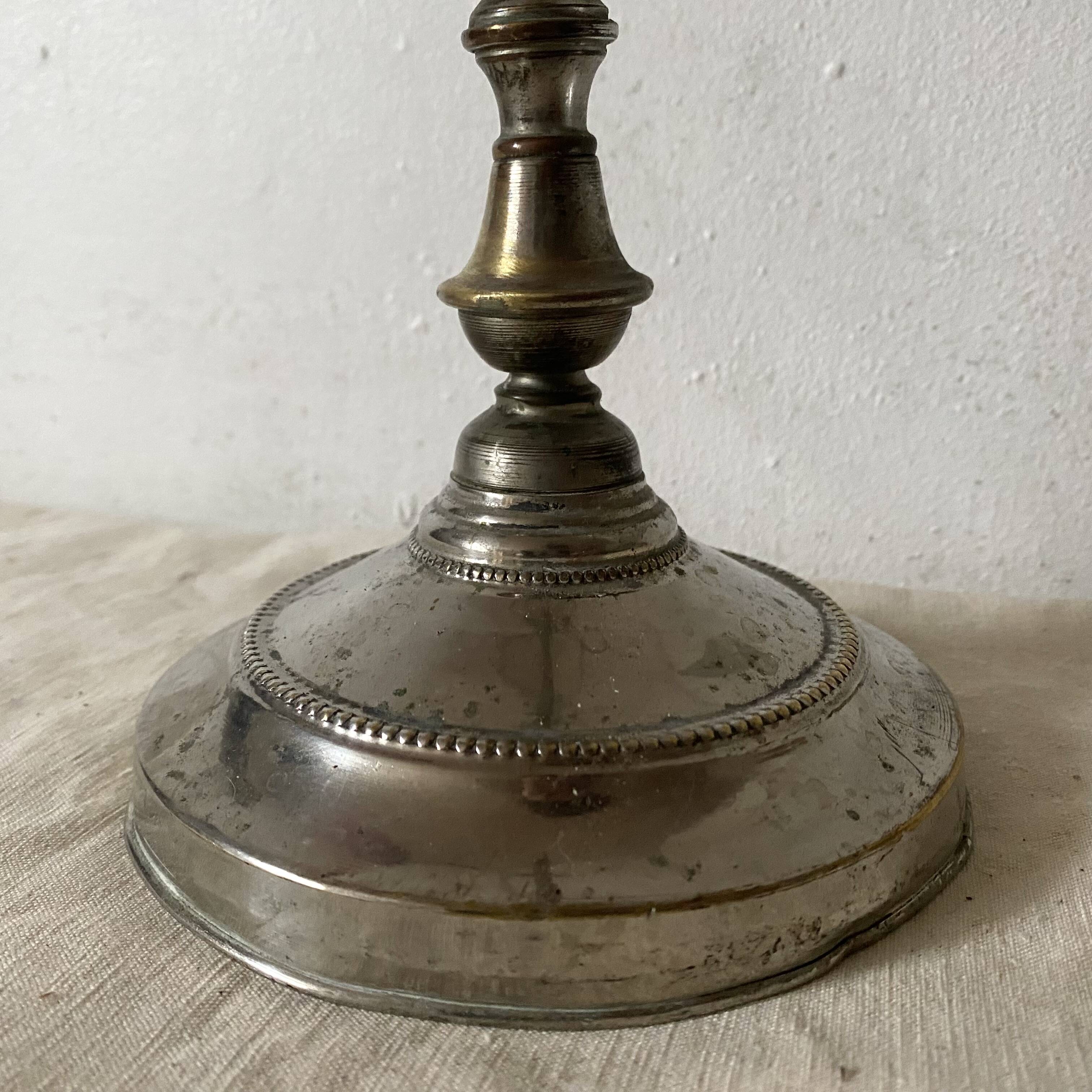 Antique jeweller's lamp, silver-plated base, frosted pink glass shade.
