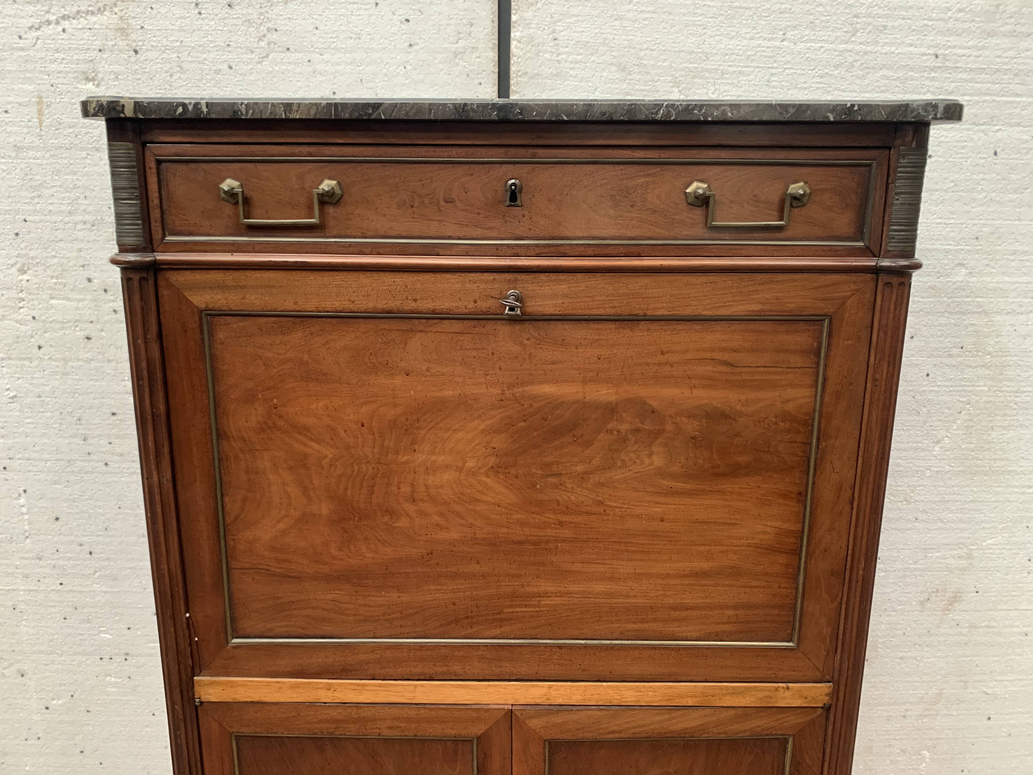 Secretary Louis XVI in mahogany Top of veined gray marble XIX century