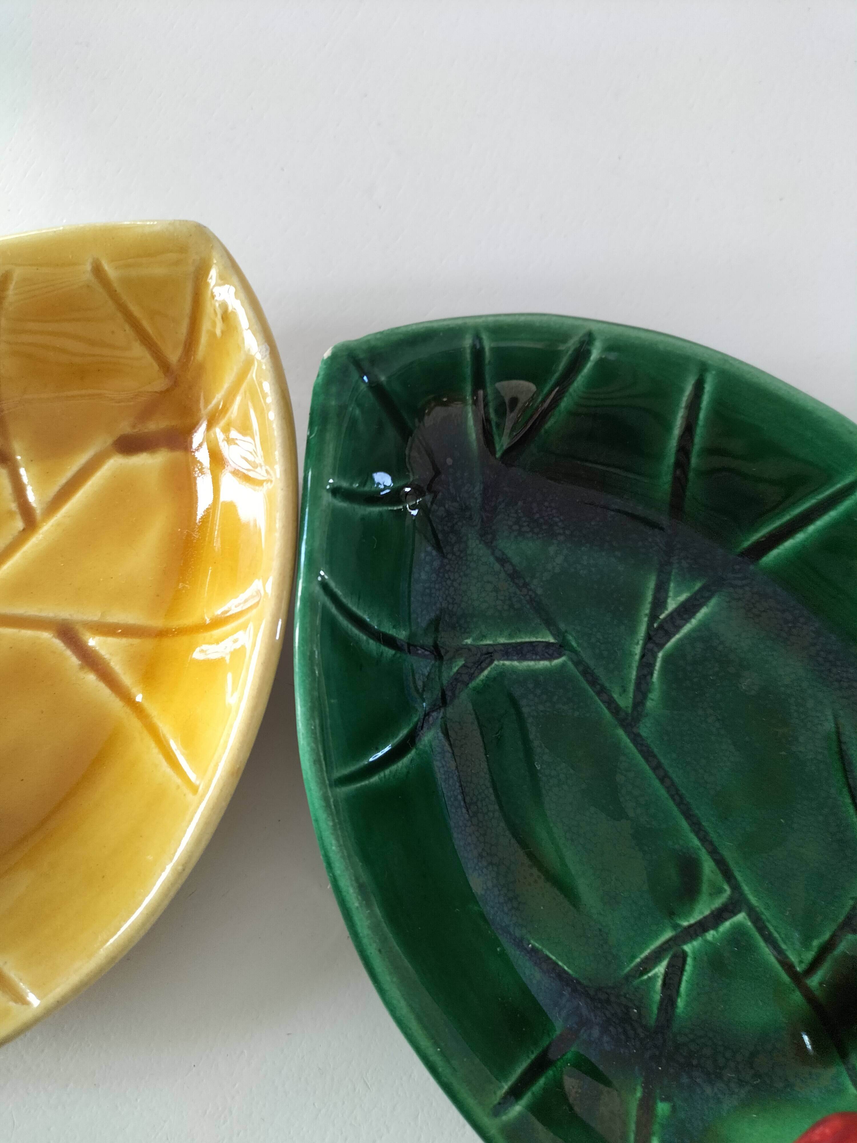 Two relief bowls with leaf designs, radishes, and tomatoes.