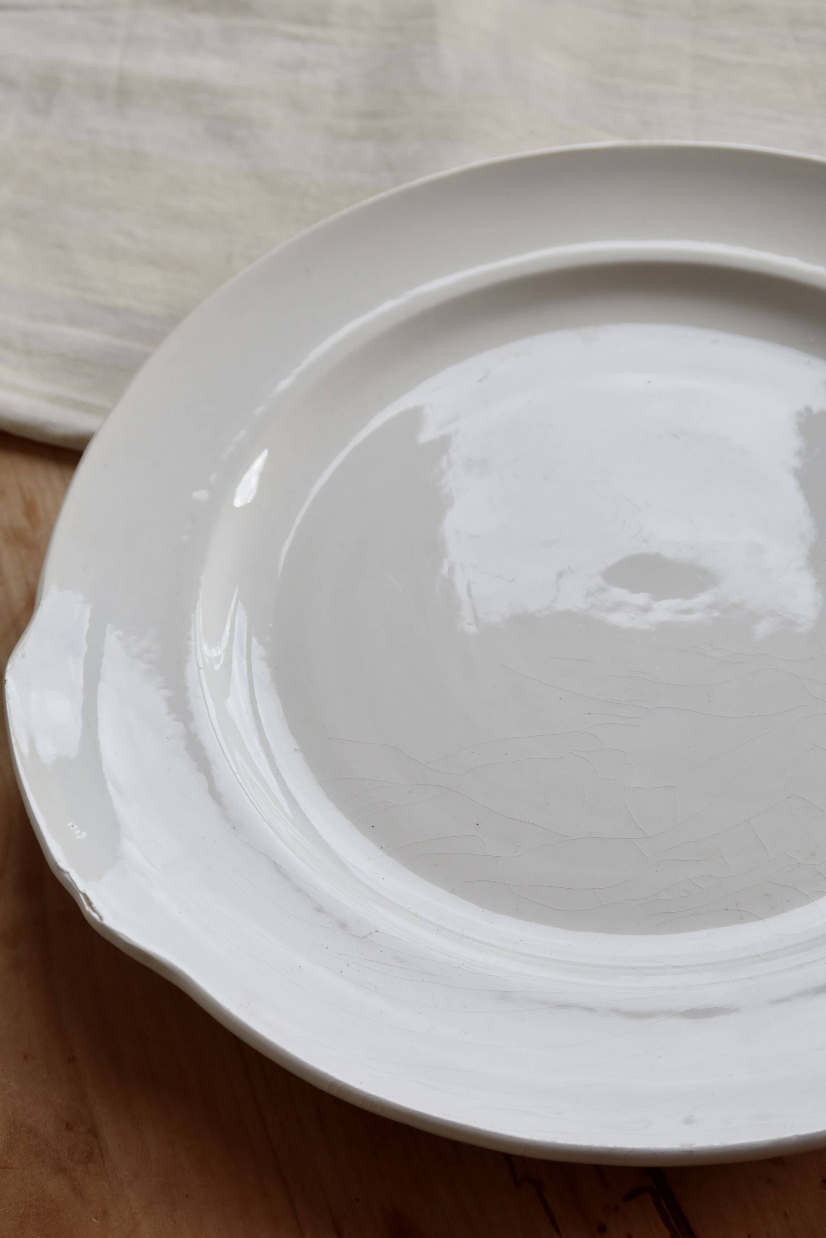 Vintage round white porcelain serving dish with handles.