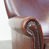 Sheepskin armchair correctly finished with decorative nails and in good condition