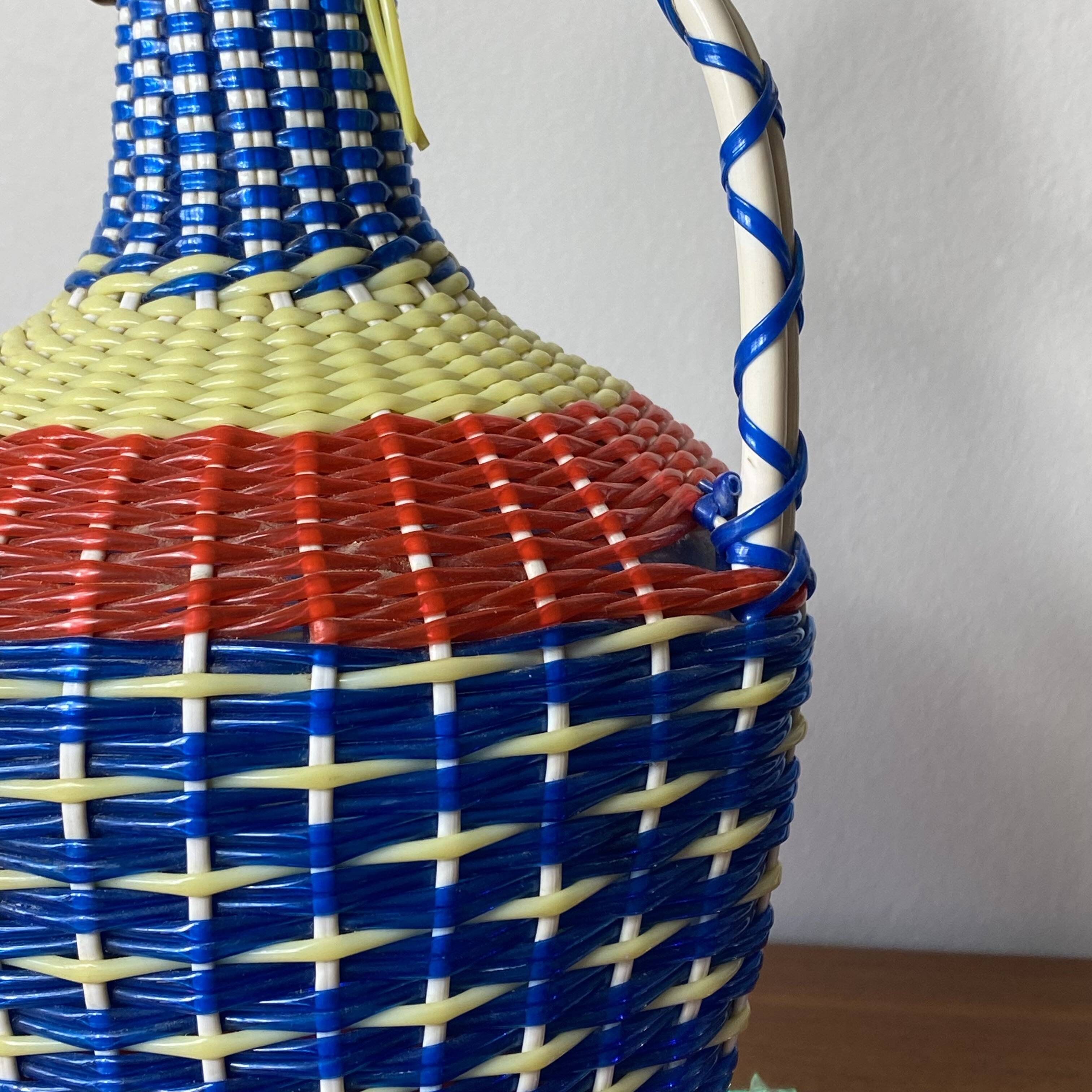 Vintage glass bottle and plastic scoubidou weaving.